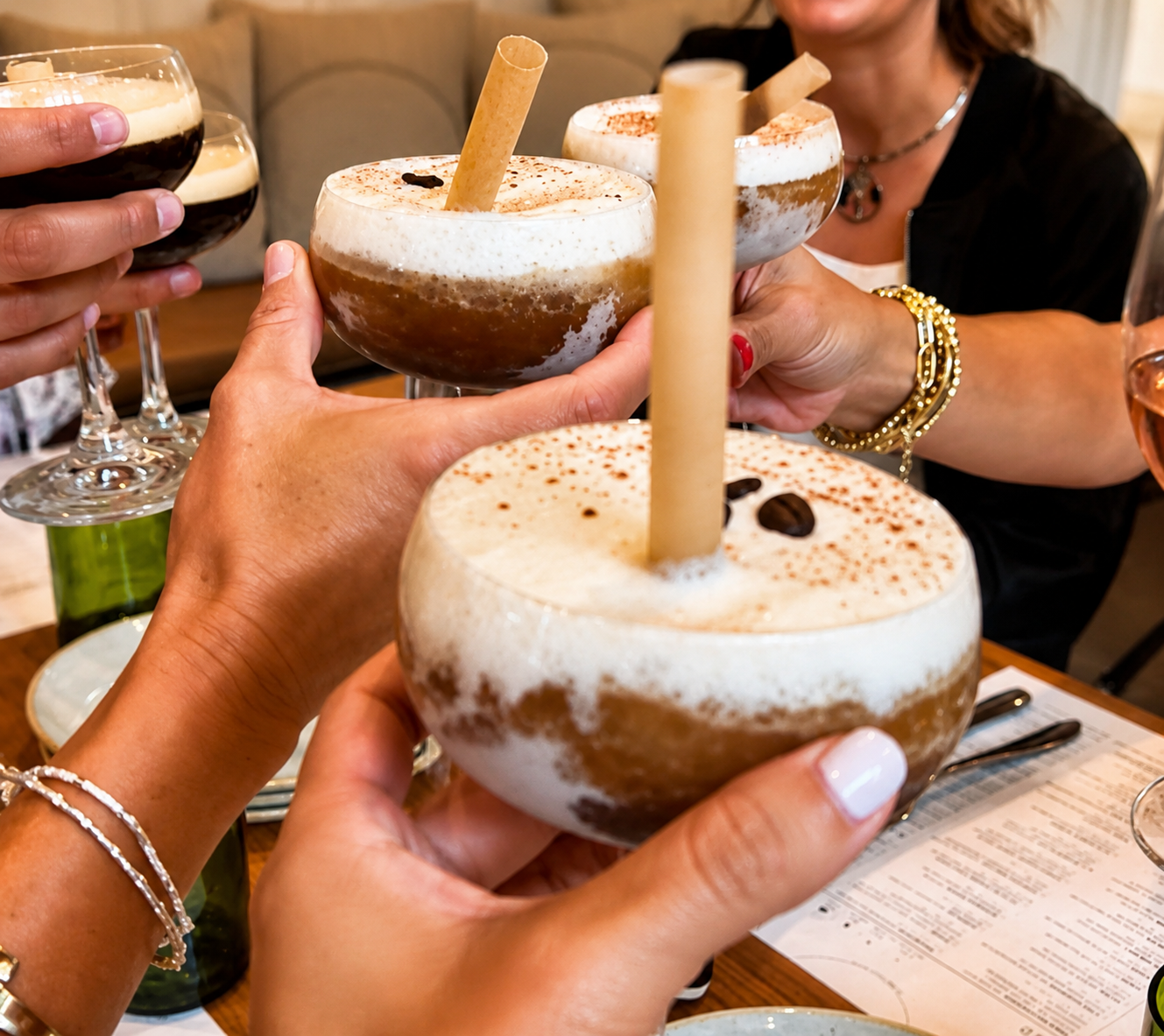 Book Fetish Momma toasting with frozen espresso martinis topped with foam and coffee beans
