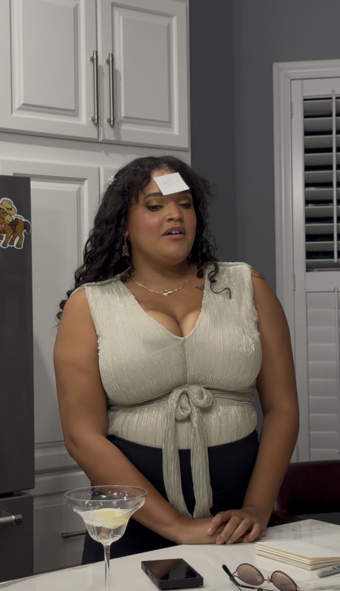 A Book Fetish Momma deep in thought with the number 32 stuck to her forehead